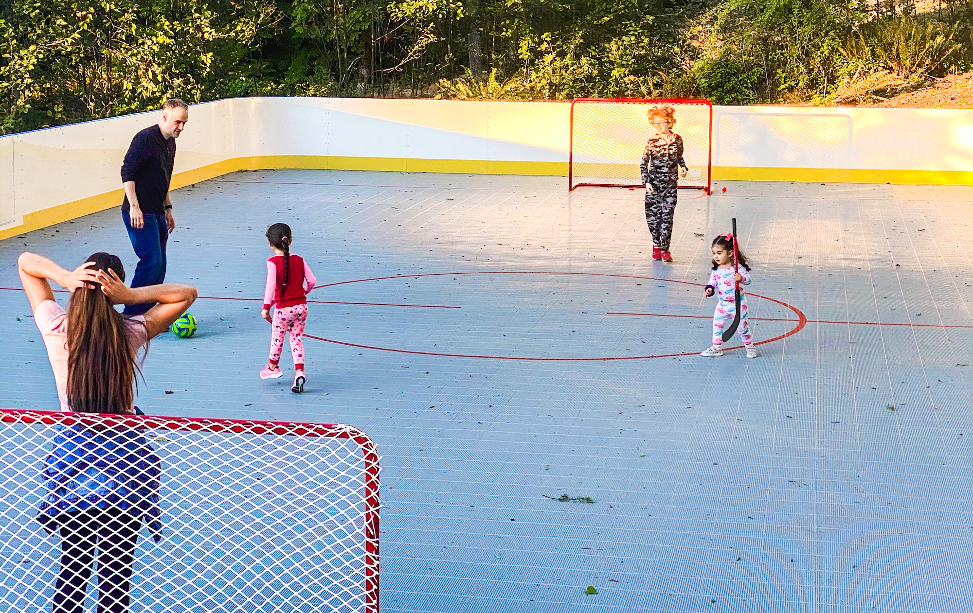 Photo of people playing soccer on outdoor rink 