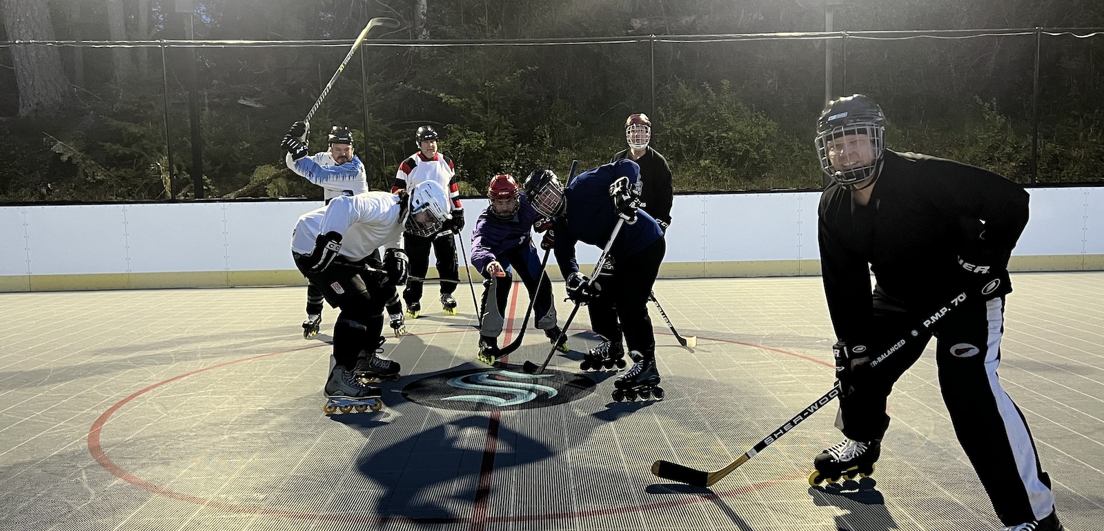 Photo of roller hockey players taking a faceoff