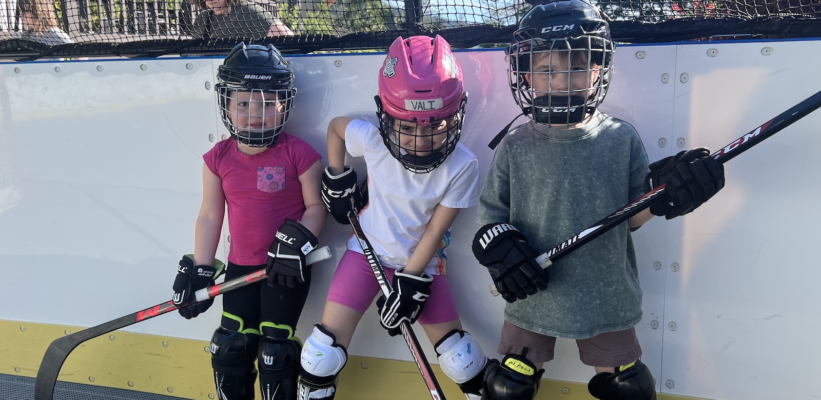 Three kids playing hockey