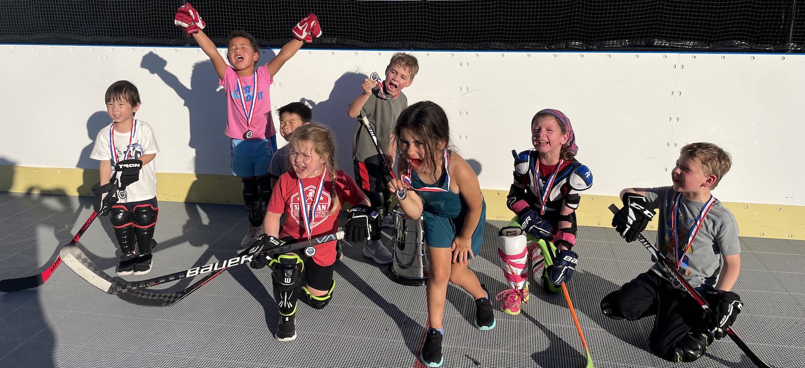 Young kids cheering after a hockey game